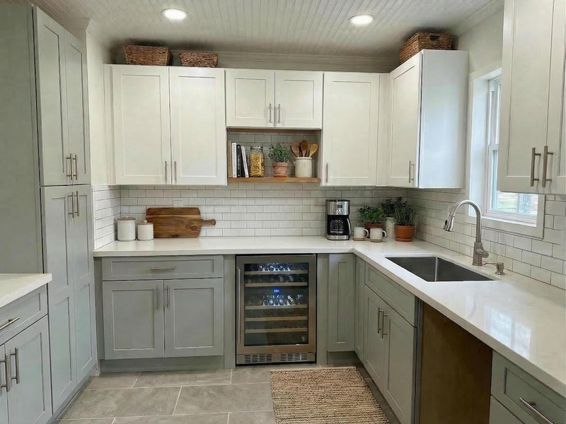 Modern kitchen with white cabinets, a wine cooler, and various appliances.